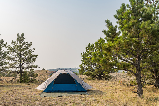 This is a photograph of a small tent setup at a campsite in Glendo State Park, Wyoming, USA.