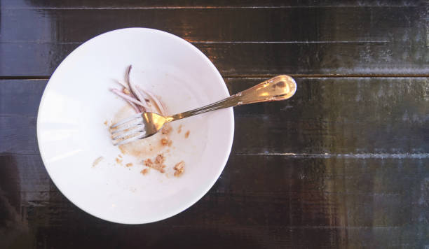 istock Salad after eating. Empty plate. Dirty restaurant bowl 1307303971