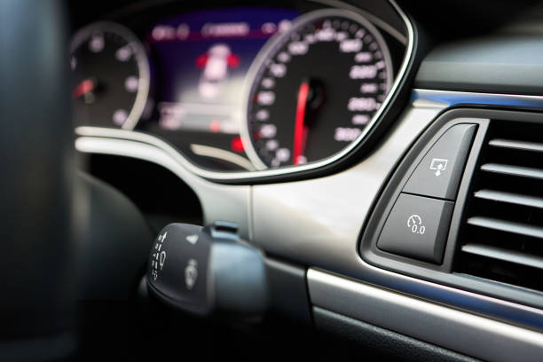 istock Modern luxury car interior Reset button for trip odometer or trip reset and Multimedia Interface display button selective focus with out of focus dashboard and steering wheel. 1307305671