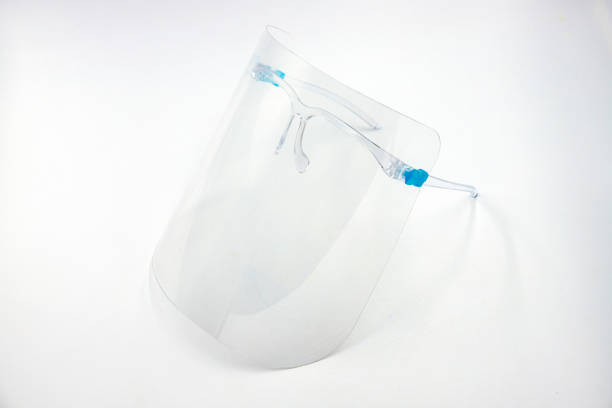 istock Plastic face shield for covid virus protection. Transparent face shield isolated on white. Surgical or medical staff equipment. Covid epidemy spread protection. Respiratory syndrome or flu prevention 1307316963