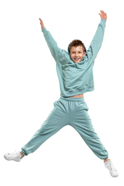 istock boy in a turquoise suit and white sneakers isolated on a white background. 1307318322