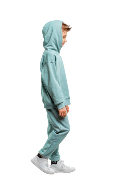 boy in a turquoise suit and white sneakers isolated on a white background.