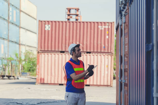 istock Foreman of container inspection workers prepare export products. Container Shipping Logistics Engineering of Import Export Transportation Industry 1307322585