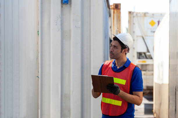 istock Foreman of container inspection workers prepare export products. Container Shipping Logistics Engineering of Import Export Transportation Industry 1307322614