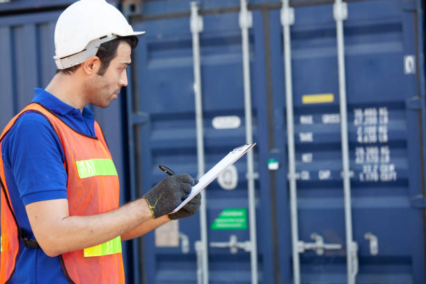 istock Foreman of container inspection workers prepare export products. Container Shipping Logistics Engineering of Import Export Transportation Industry 1307322636