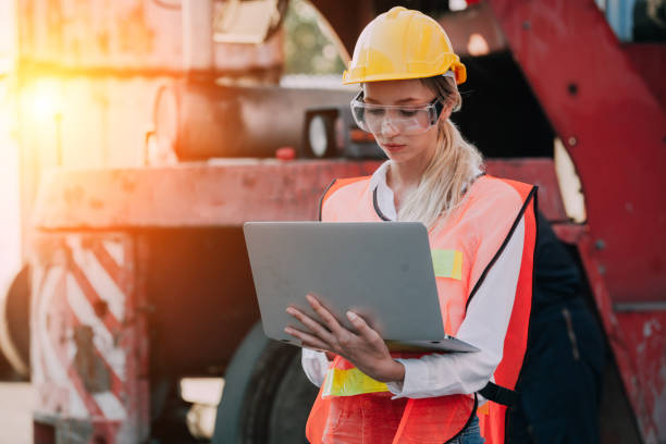 istock woman working with laptop in cargo container. Containers box from Cargo freight ship for import export. Business logistic concept, Import and export concept 1307322661