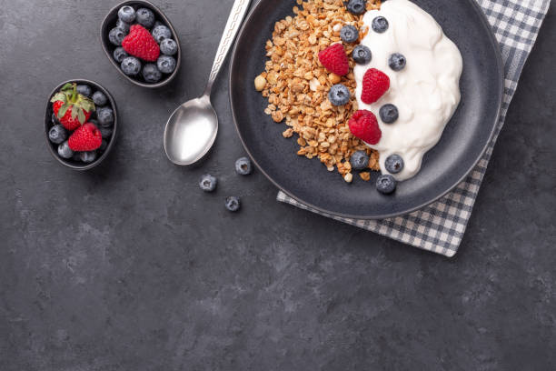 istock Healthy breakfast with baked granola and greek yogurt. Assorted fresh berries 1307323695