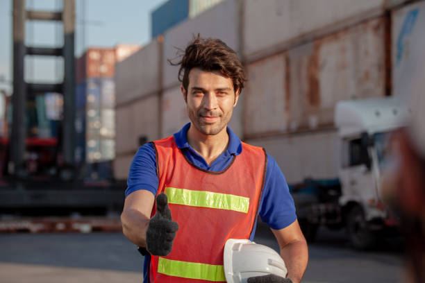 istock worker thumbs up sucess working.  workers prepare export products. Container Shipping Logistics Engineering of Import Export Transportation Industry 1307324340
