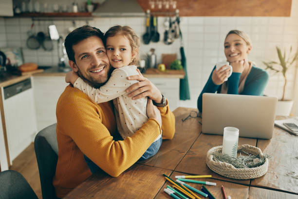 istock Happy father and daughter embracing at home. 1307328603