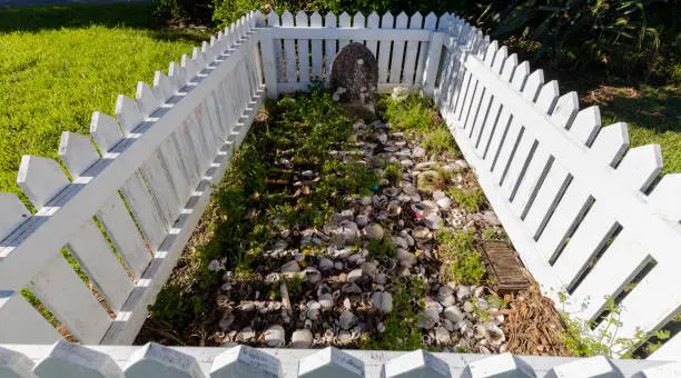 Photo of Grave inside a white picket fence