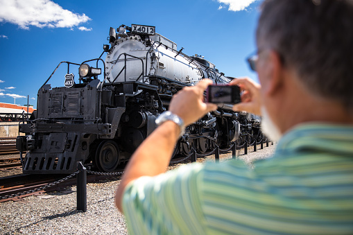 Senior man taking a photo of Union Pacific Big Boy Steam Locomotive X4012 in Scranton, PA the Union Pacific Big Boy Steam Locomotive X4012 in Scranton, PA