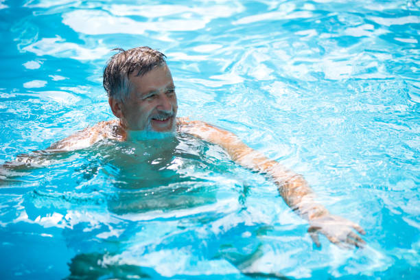 istock Senior man in his home swimming pool 1307332211