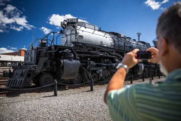 Senior man taking a photo of Union Pacific Big Boy Steam Locomotive X4012 in Scranton, PA the Union Pacific Big Boy Steam Locomotive X4012 in Scranton, PA