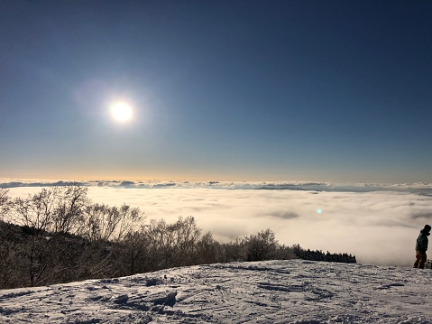 Sunset in mountains, above clouds