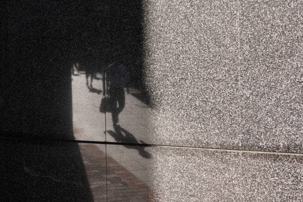 istock Reflective wall showing people walking along the footpath 1307335188