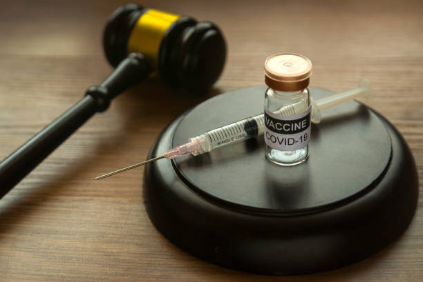 law and vaccination concept. selective focus of bottle of covid-19 vaccine, gavel and syringe on wooden background. - gavel mallet law legal system imagens e fotografias de stock