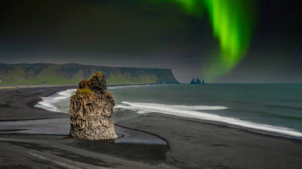 istock The Arnardrangur sea stack in Iceland, with the northern lights in the background. 1307337290