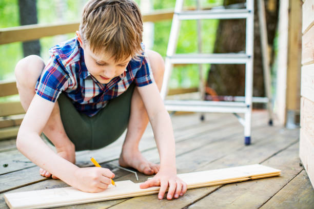 istock Father and son building tree house at backyard 1307338366
