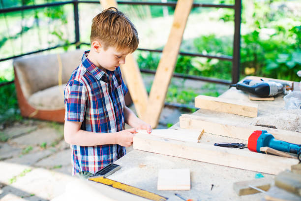 istock Father and son building tree house at backyard 1307338372