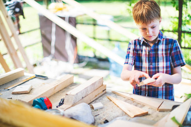 istock Father and son building tree house at backyard 1307338373