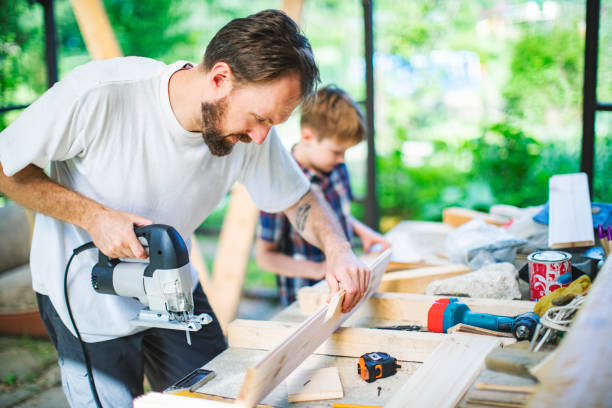 istock Father and son building tree house at backyard 1307338389