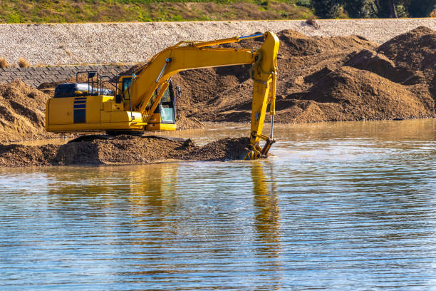 istock Hydraulic excavator digging up the sand in the river 1307340616