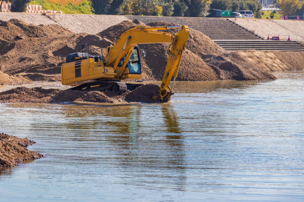 istock Hydraulic excavator digging up the sand in the river 1307340629