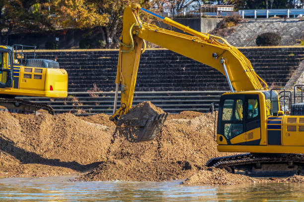 istock Hydraulic excavators digging up soil on the riverbank 1307340675