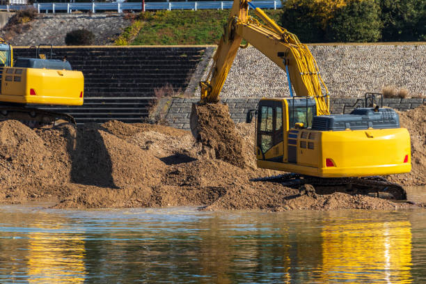 istock Hydraulic excavators digging up soil on the riverbank 1307341200