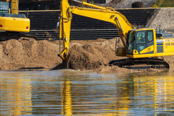 istock Hydraulic excavators digging up the sand in the river 1307341238