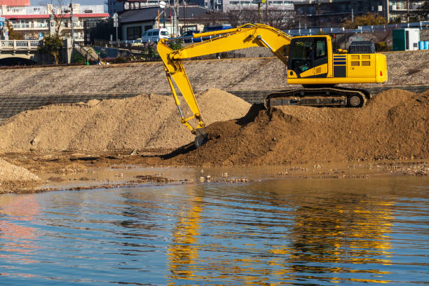 istock Hydraulic excavator digging up soil on the riverbank 1307341252