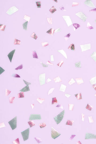 istock shiny metallic confetti on a purple pink background 1307343515