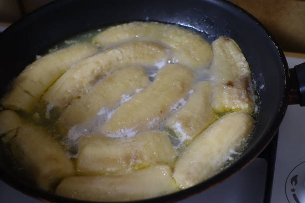 istock Bananas being cooked with butter in a frying pan before being flamed 1307344839