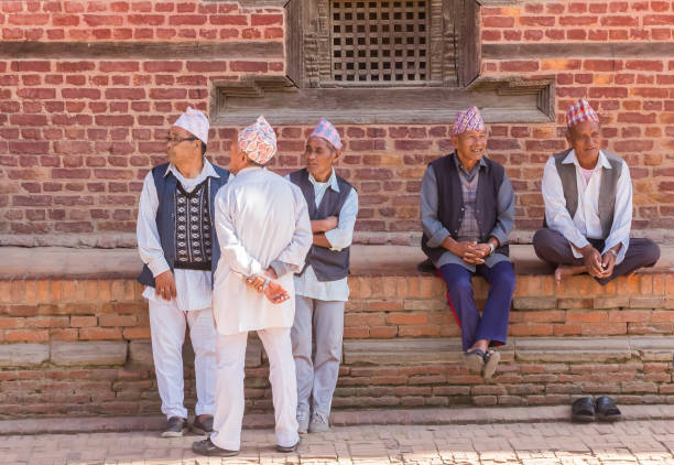 Senior men sitting and talking on Durbar square in Patan, Nepal