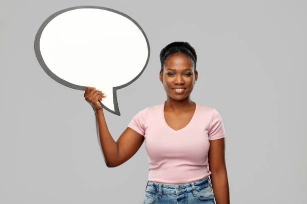 istock happy african american woman holding speech bubble 1307345077