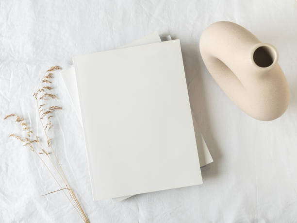 istock Empty blank white magazine cover mock up, vase and dried grass 1307346877