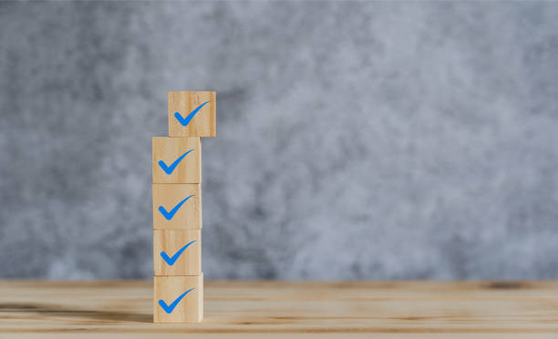 istock Object on the table of icon sign checklist on wooden block stacking same as step stair up on the blurred grey background, Business mark up concept. copy space for text. Clipboard and check marks 1307349770