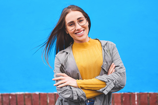 Shot of a beautiful young woman smiling against a blue background