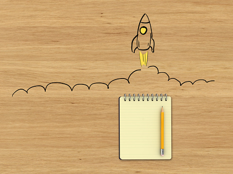Start idea brainstorming rocket business desk notepad