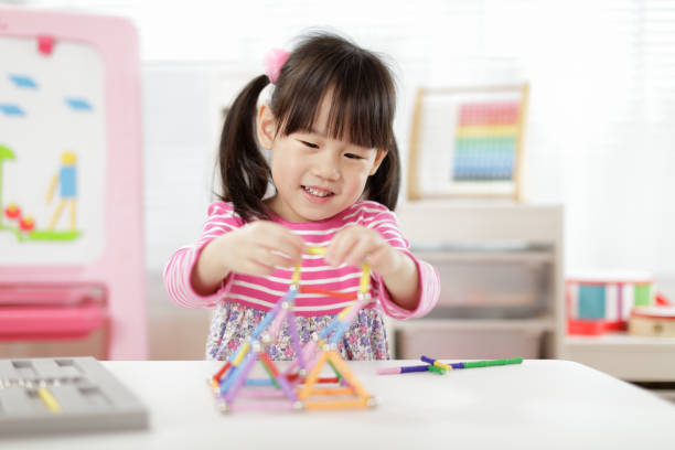 istock Young Girl Playing Creative 3D Shape Toy For Homeschooling 1307353270