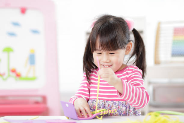 istock Young Girl Sweing Pad Craft Using Plastic Needle And Yarn For Homeschooling 1307353285