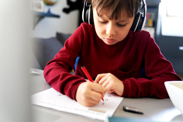 istock Close up of boy doing homework during a lockdown 1307353526