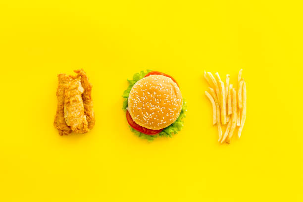 istock Fast food flat lay set. Burger with fried potatoes and chicken, top view 1307354457