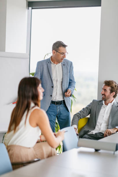 istock Senior manager pointing at figures on flipchart 1307355845