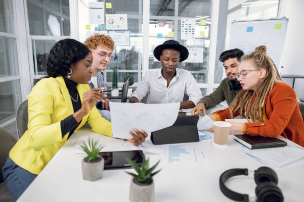 istock Multiracial IT specialists working with graphs and charts 1307356046