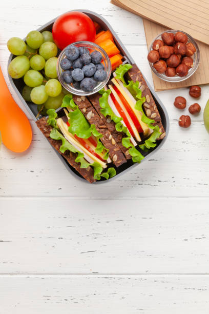 istock Healthy school lunch box with sandwich and fresh vegetables 1307356306