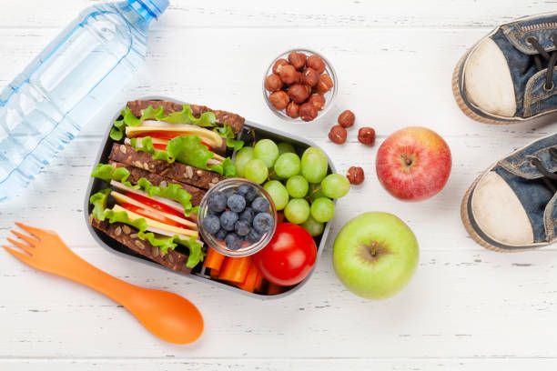 istock Healthy school lunch box with sandwich and fresh vegetables 1307356347