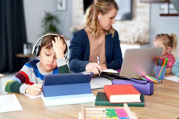 istock Mother working with children at home in quarantine isolation 1307356399