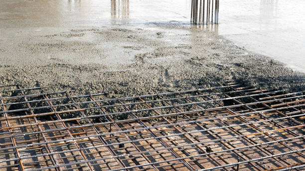 Closeup of steel reinforcement on the floor for pouring concrete Closeup of steel reinforcement on the floor for pouring concrete. Construction of new residential high-rise buildings. reinforced concrete stock pictures, royalty-free photos & images