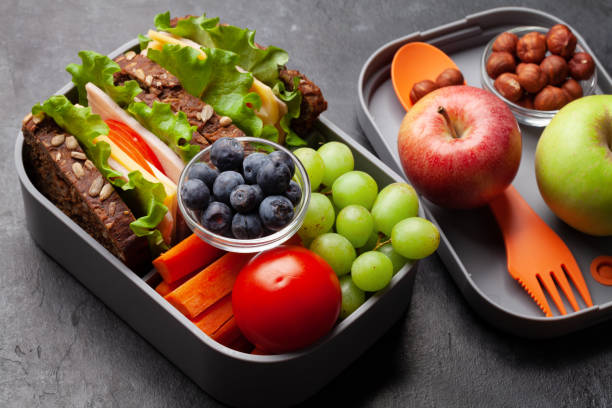 istock Healthy school lunch box with sandwich and fresh vegetables 1307356657
